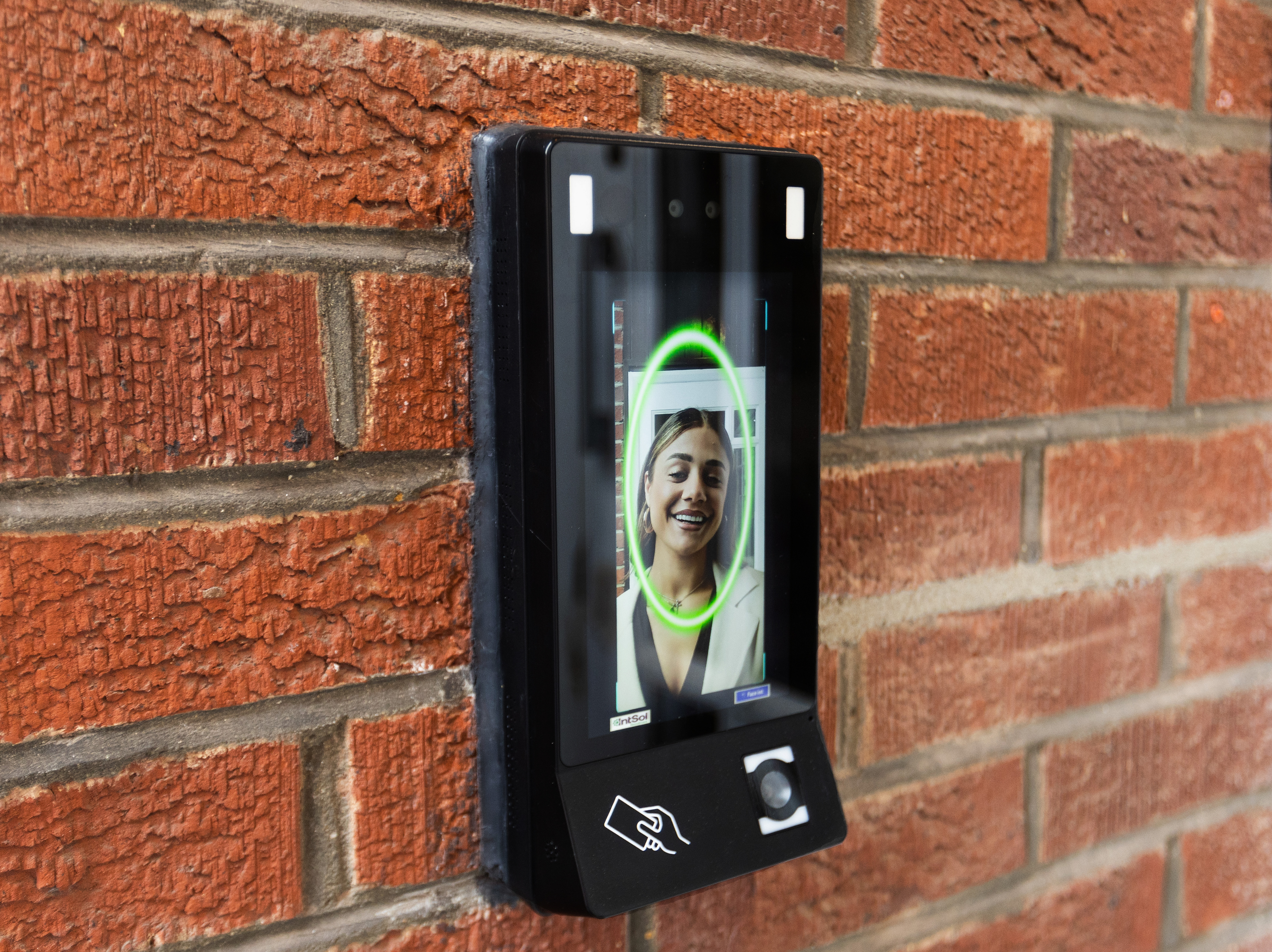 Face Int access-control device mounted on a wall verifying a user